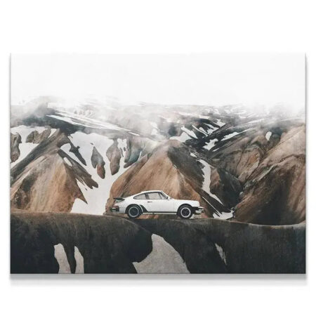 Epic mountain landscape featuring classic white sports car, designed to 'Blend In' with the rugged terrain.