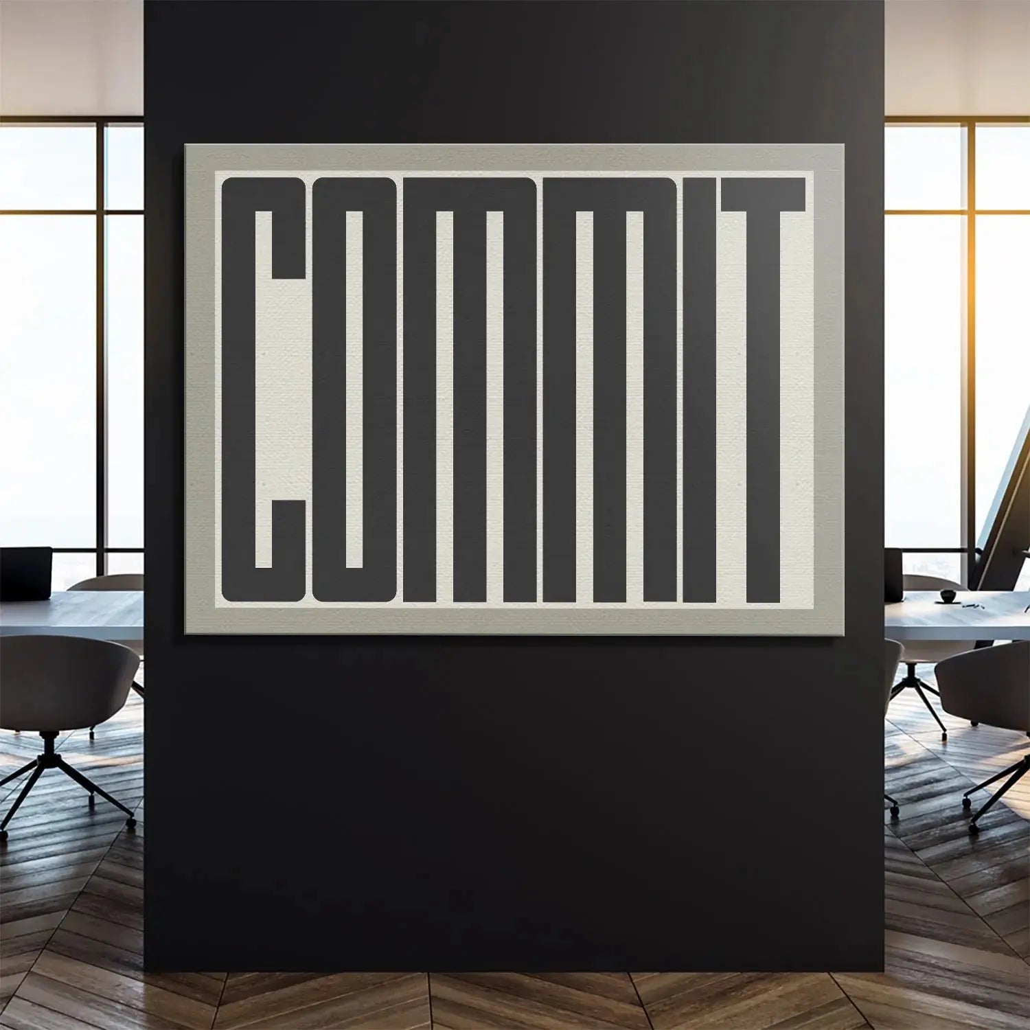 Lifestyle image of the large Commit motivational print mounted above a modern, minimalist desk setting.