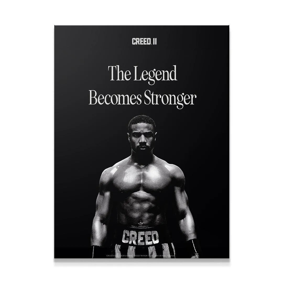 Adonis Creed facing forward in dramatic lighting, showcasing the intensity of Creed - The Legend poster art.