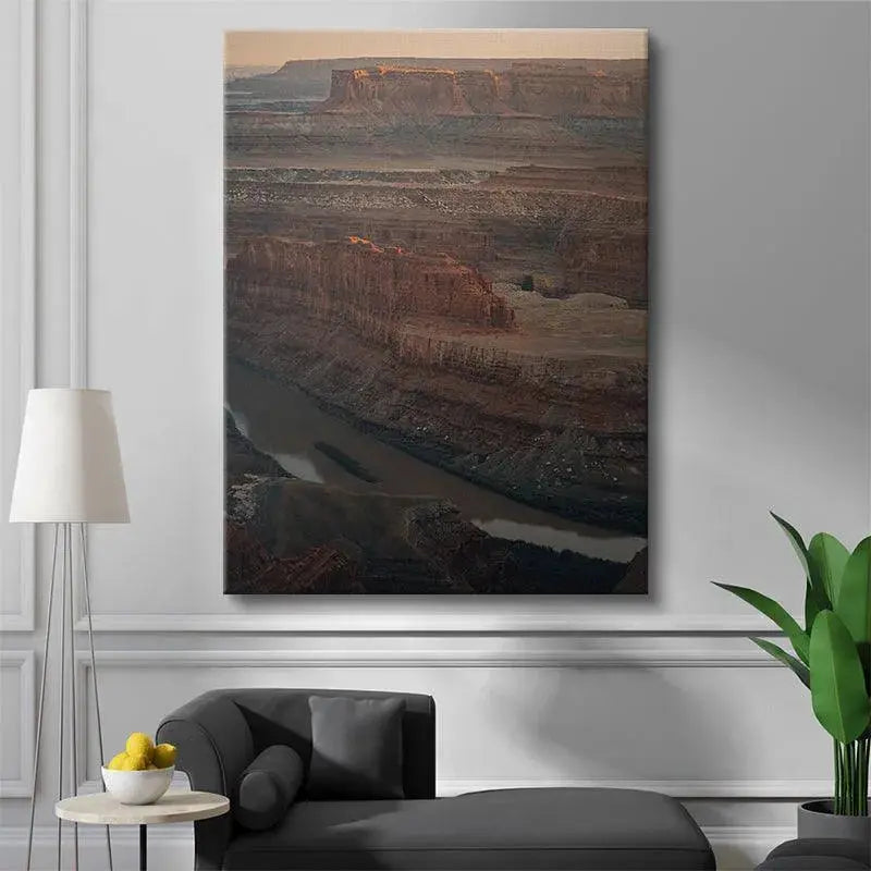 Vertical perspective of the muddy river cutting through the deep canyon floor in Dead Man's Land artwork.