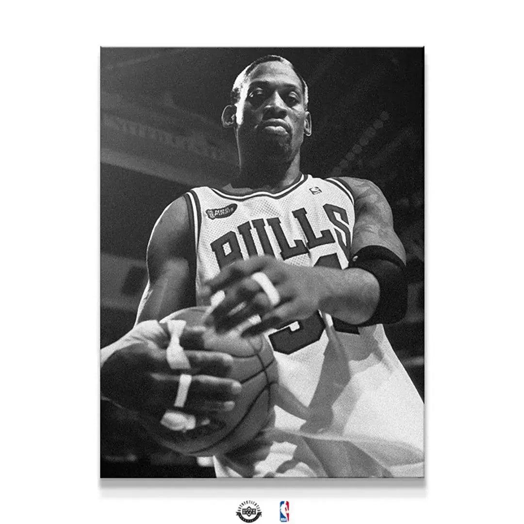 Low-angle close-up of Dennis Rodman - Bullish holding the basketball, showing fierce determination.