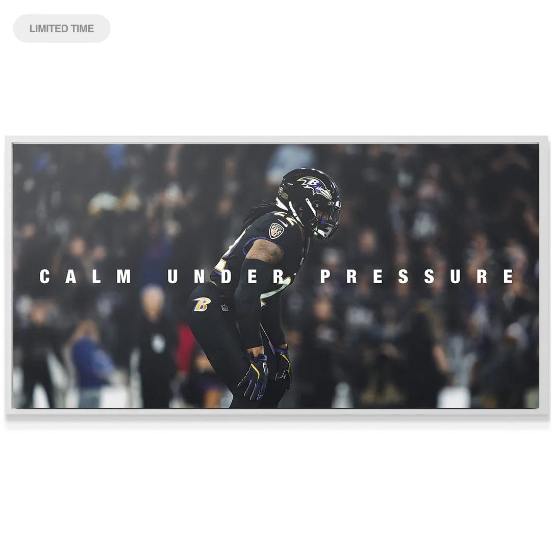 Lifestyle image of the Derrick Henry - Calm Under Pressure canvas hanging on a dark gray living room wall.