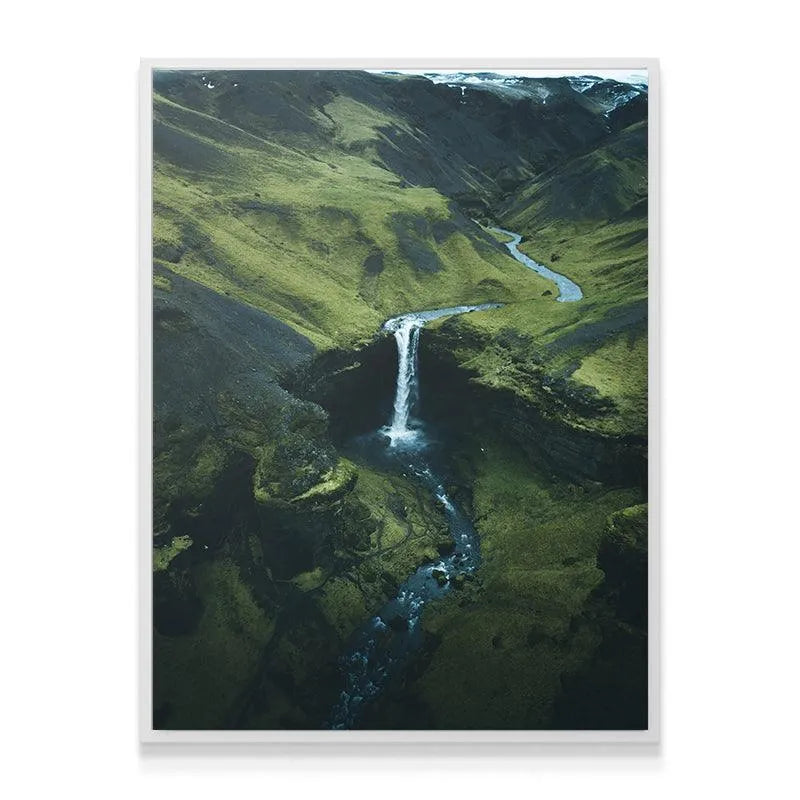 Wide shot of the deep green valley and winding river captured by DJI for scale.
