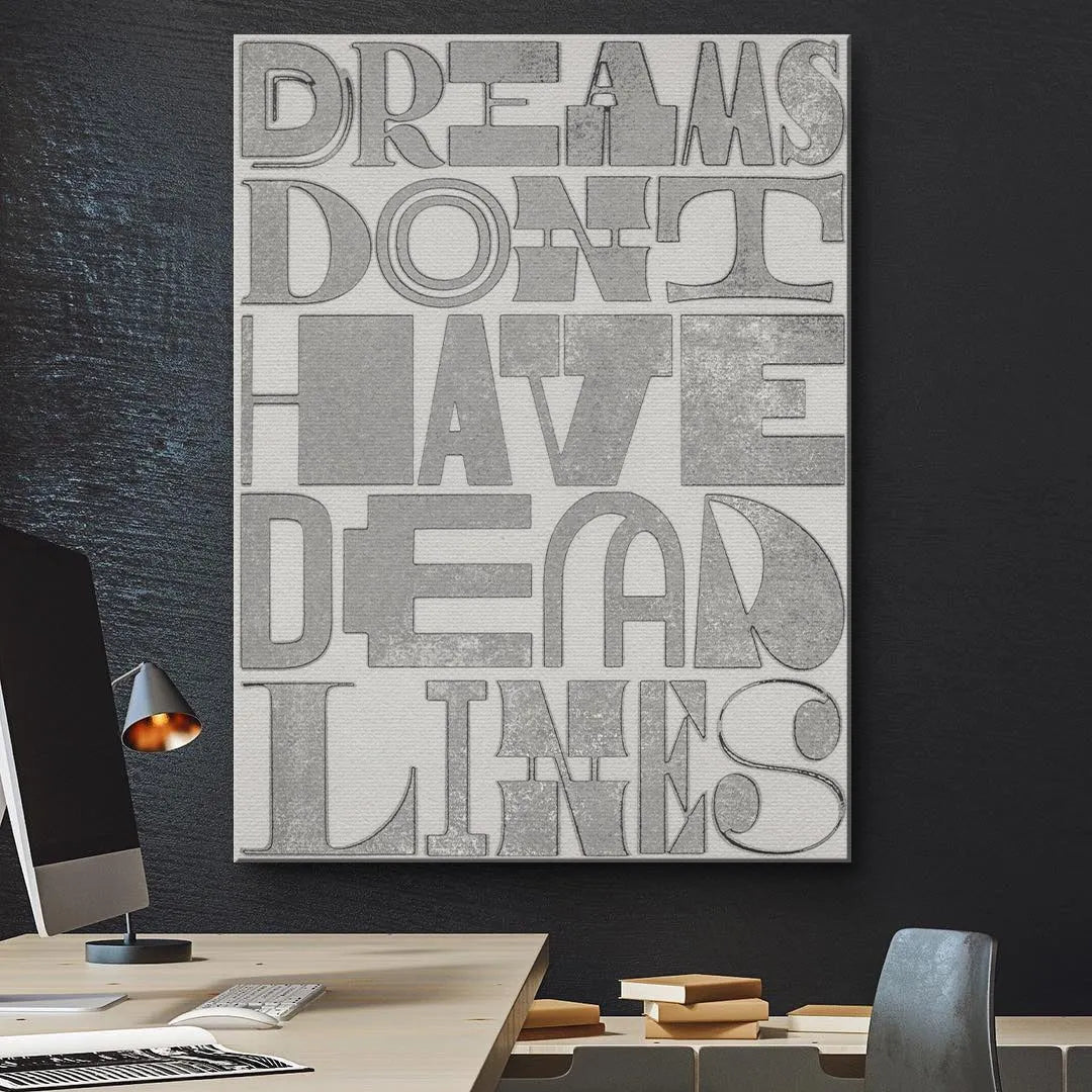 High-angle view emphasizing the shadow and depth of the embossed lettering 'Dreams Don't Have Deadlines'.