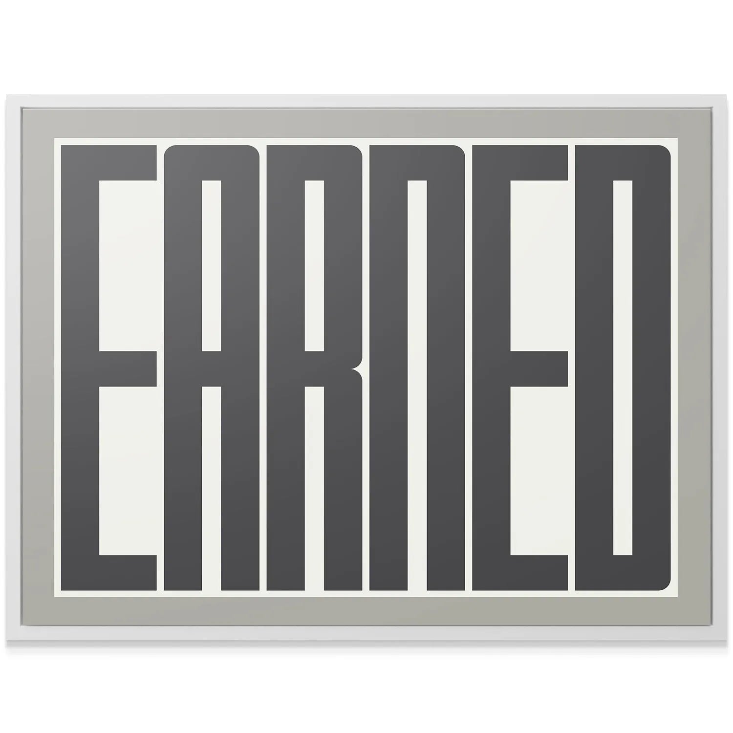 Lifestyle shot of the 'Earned' poster hanging above a modern desk in a professional office setting.