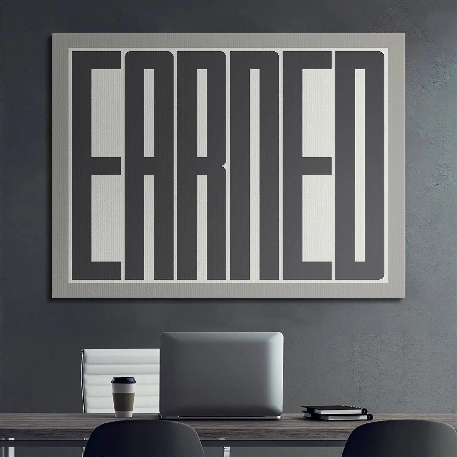 Corner view highlighting the matte gray border surrounding the impactful 'Earned' artwork.