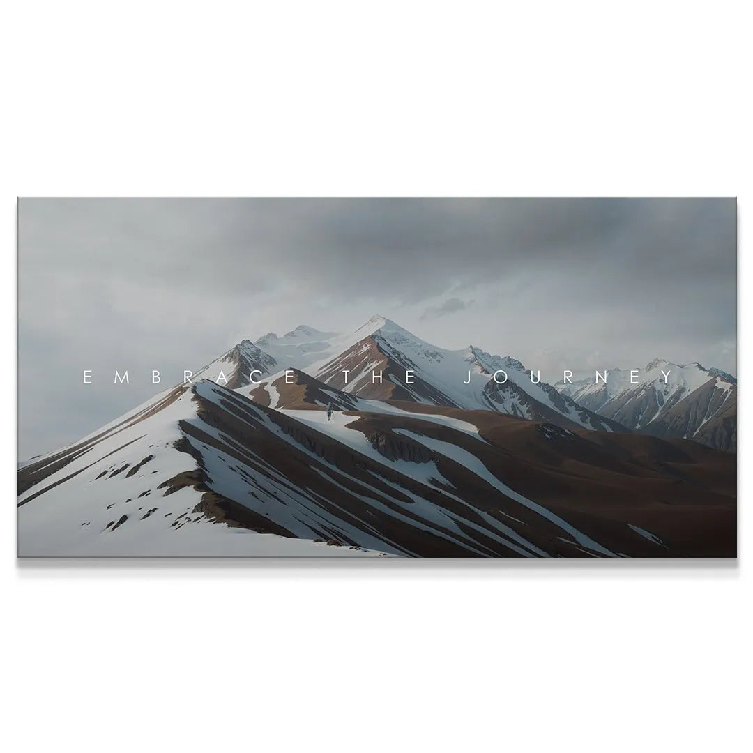 Wide shot of snow-dusted, rugged mountains emphasizing the motivational text 'Embrace The Journey'.