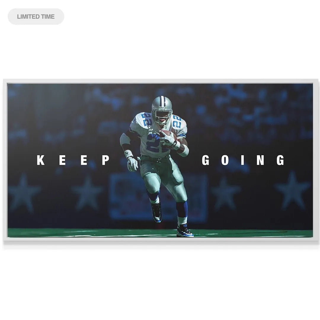 Wide panoramic view of the iconic 'Emmitt Smith - Keep Going' art installed over a modern office desk.