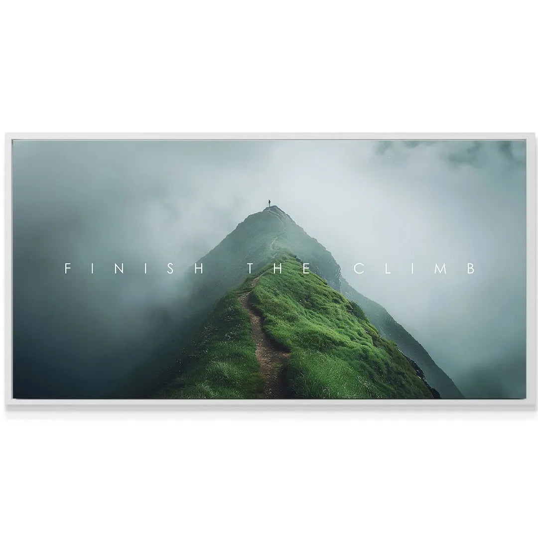 Lifestyle mock-up of the artwork hanging over a modern desk, encouraging the viewer to Finish The Climb.
