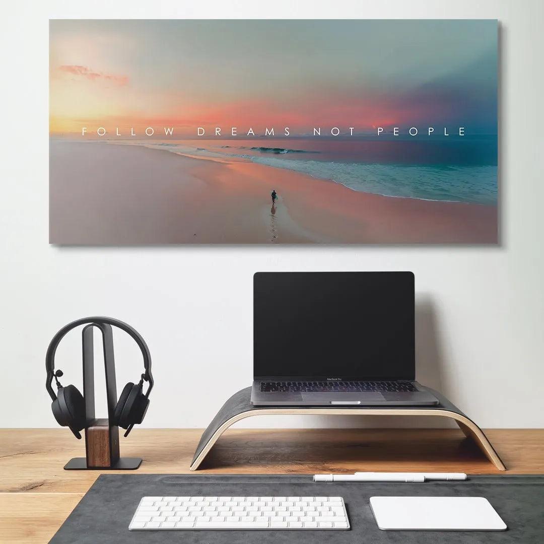 Motivational wall art featuring a person running towards the horizon below the powerful quote "Follow Dreams Not People."