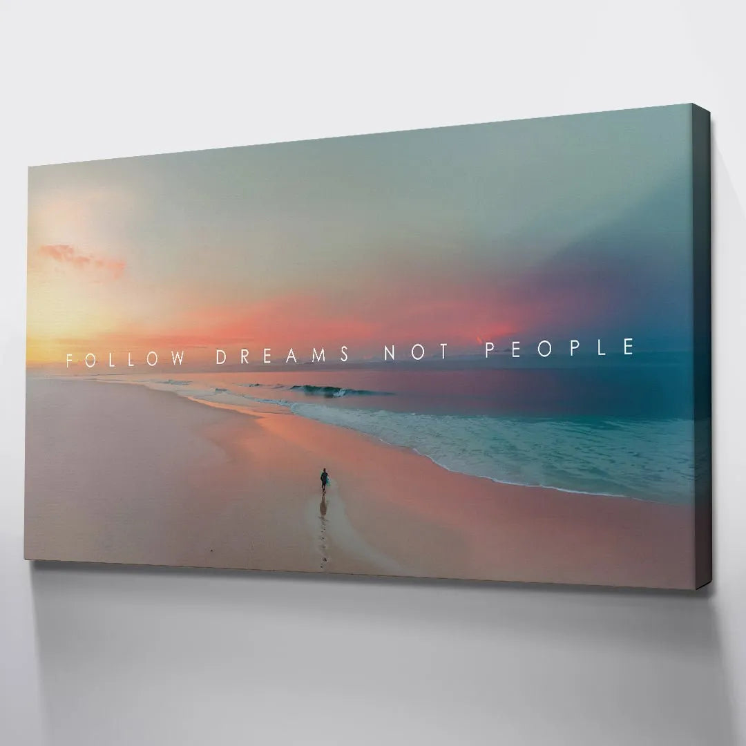 Overhead perspective showcasing the vast stretch of beach and the small waves near the "Follow Dreams Not People" canvas print.