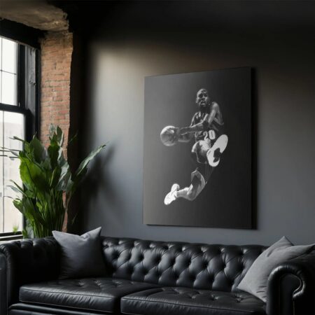 Lifestyle view of large black leather sofa featuring the 'Gary Payton - Pass' canvas art prominently displayed.