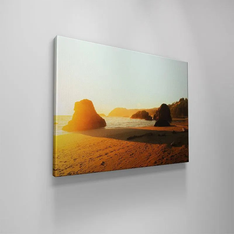 The horizontal composition highlighting the ocean waves and distant mountains catching the intense 'Golden Glow'.