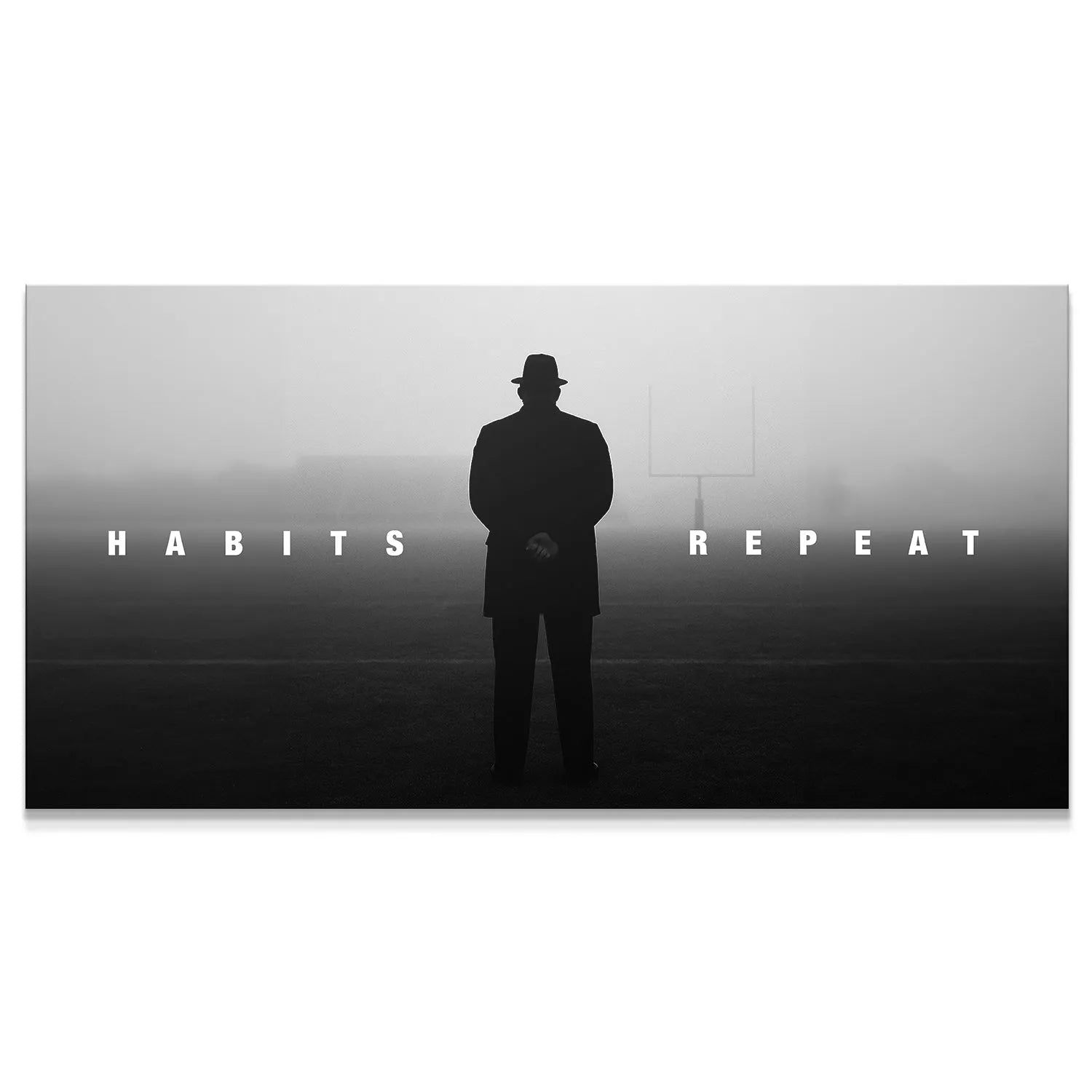 Atmospheric wide shot of silhouetted coach figure on misty football field with the motivational text 'Habits Repeat'.