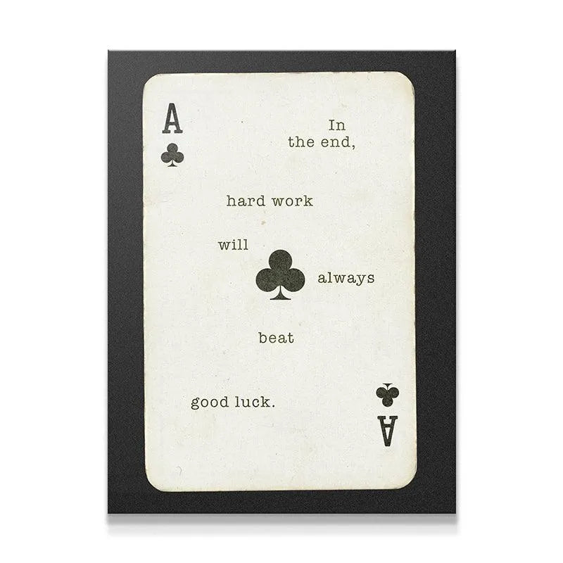 Close-up view of the central Ace of Clubs symbol on the print that reads 'Hard Work Beats Good Luck'.