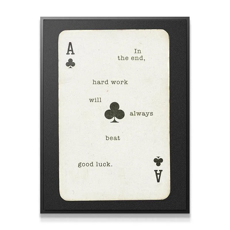 Full straight-on shot of the framed motivational print confirming that Hard Work Beats Good Luck.