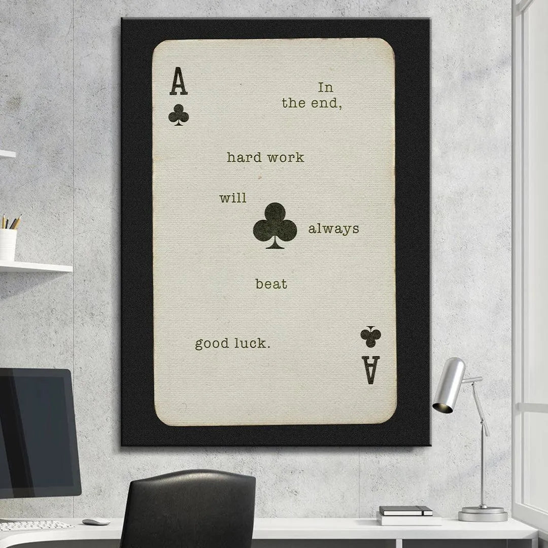 Lifestyle shot of the 'Hard Work Beats Good Luck' poster hanging above an executive desk.