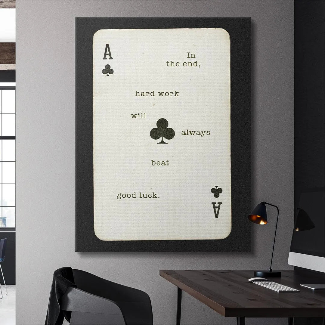Angled photograph highlighting the subtle shadow drop and black border of the 'Hard Work Beats Good Luck' print.