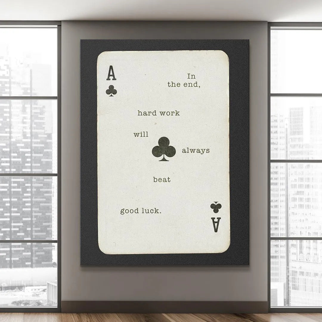 A high-resolution image of the top left corner showing the 'A' and club icon on the 'Hard Work Beats Good Luck' artwork.