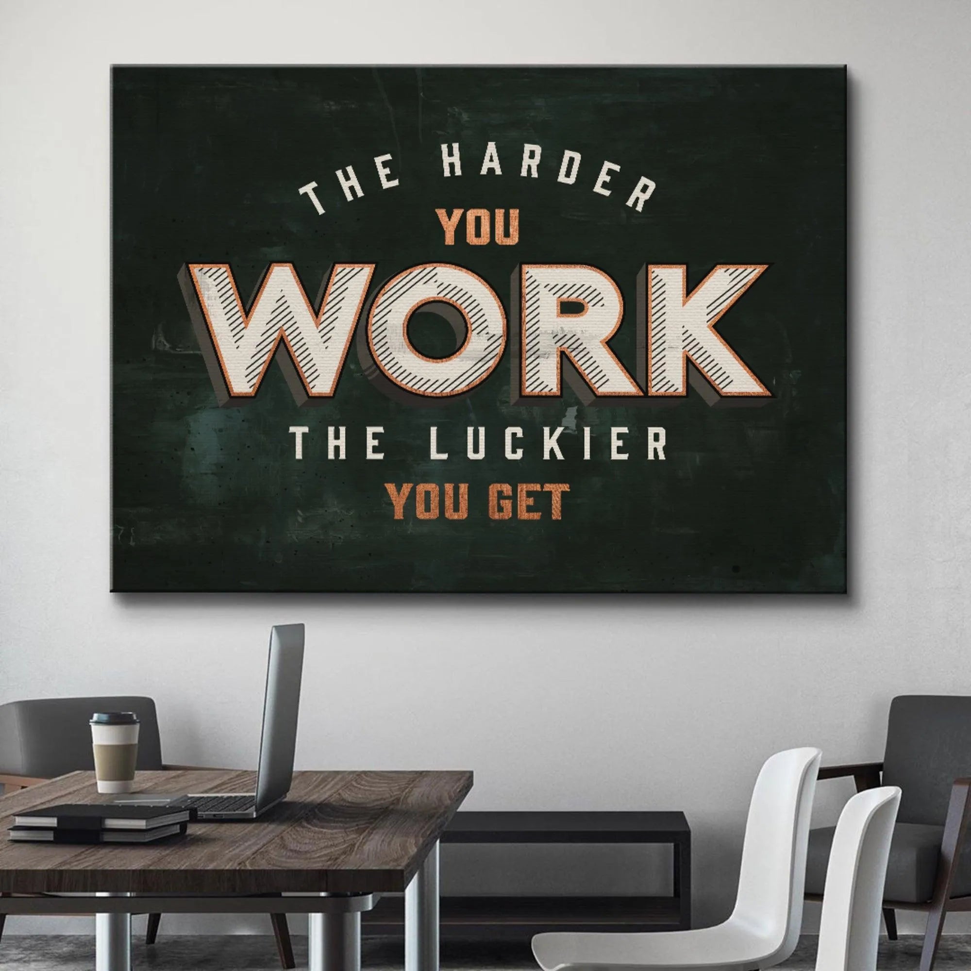 Angled shot of the retro poster emphasizing the powerful message 'Harder You Work' in a home office setting.