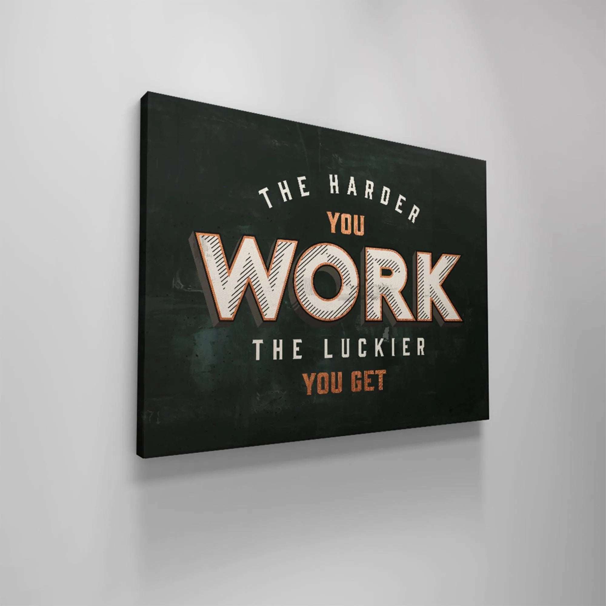 High-contrast detail highlighting the white, orange, and dark green colors used in the 'Harder You Work' design.