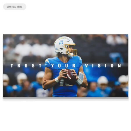 Close-up view of the football being held in the 'Justin Herbert - Trust Your Vision' canvas print, highlighting the texture.