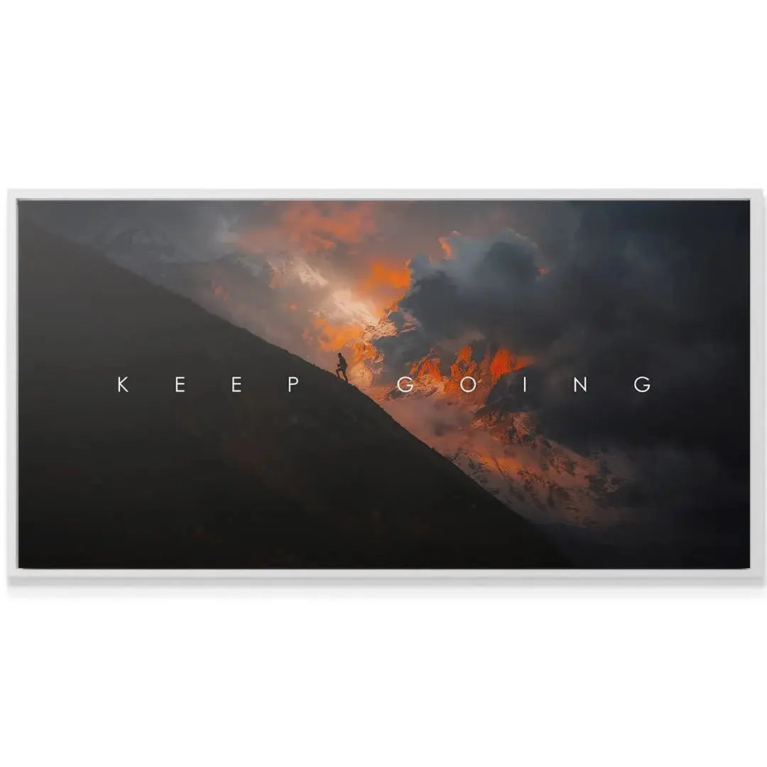 Lifestyle mock-up of the large Keep Going Sunset canvas mounted above a modern desk.