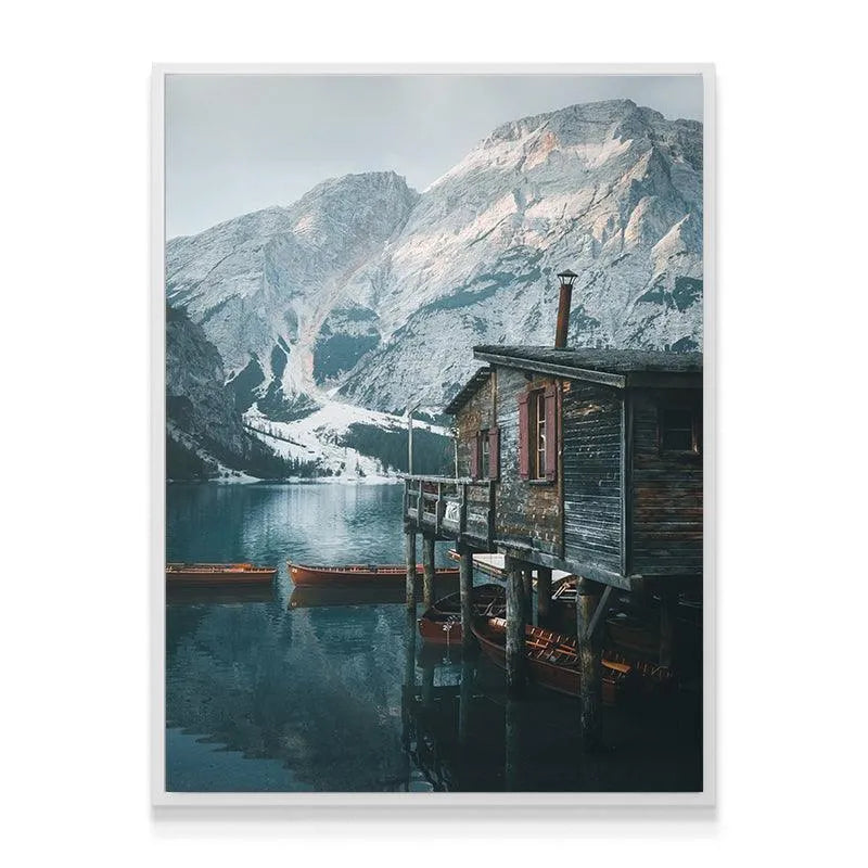 Wide shot perspective of the snow-capped mountains towering over Lago Di Braies.