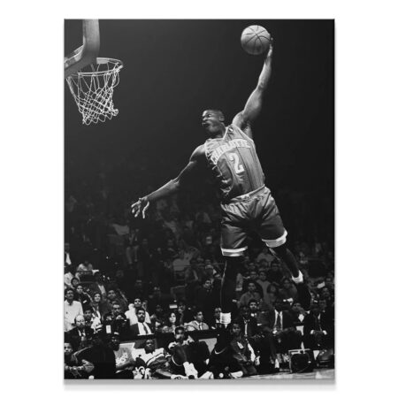 High-contrast black and white action shot of Larry Johnson - #1 executing a ferocious dunk over the crowd.