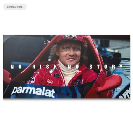 Full view of Niki Lauda smiling in the race car cockpit featuring the mantra: Lauda - No Risk No Story.