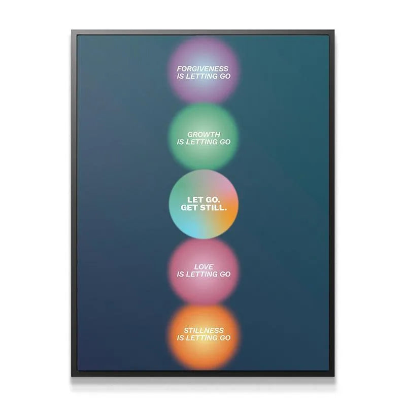 Lifestyle shot of the Let go, Get Still print hanging above a minimalist yoga mat in a sunny studio.