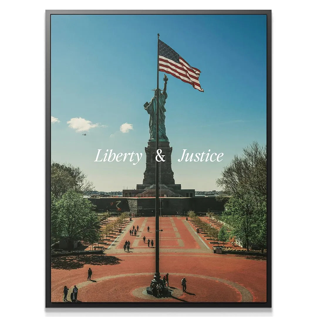 Wide-angle shot showing the red plaza and distant tourists beneath the 'Liberty & Justice 2' artwork.