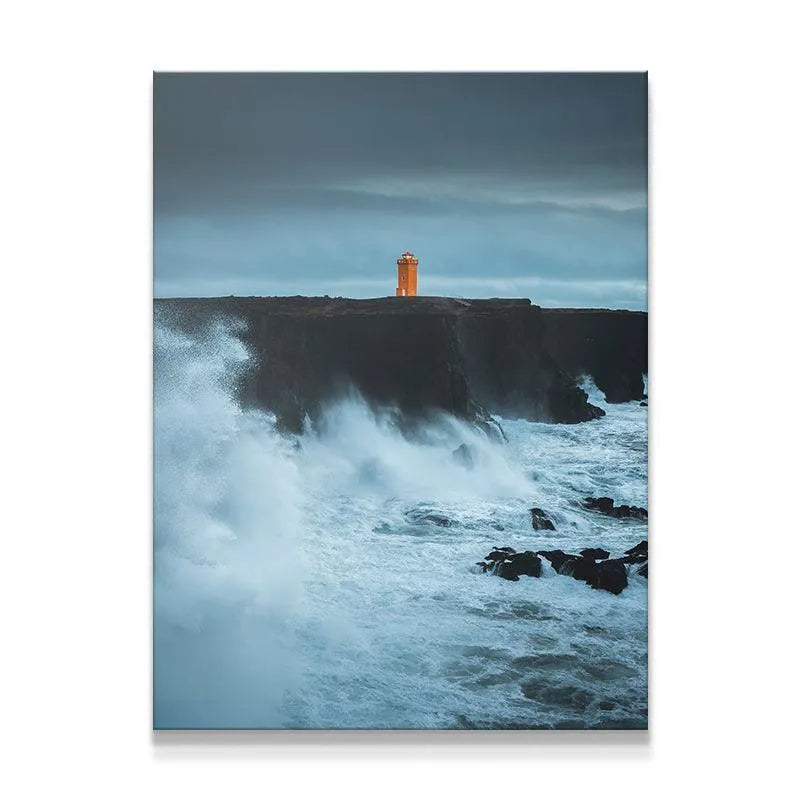 Full view of the dramatic coastal Lighthouse standing firm against huge ocean waves.
