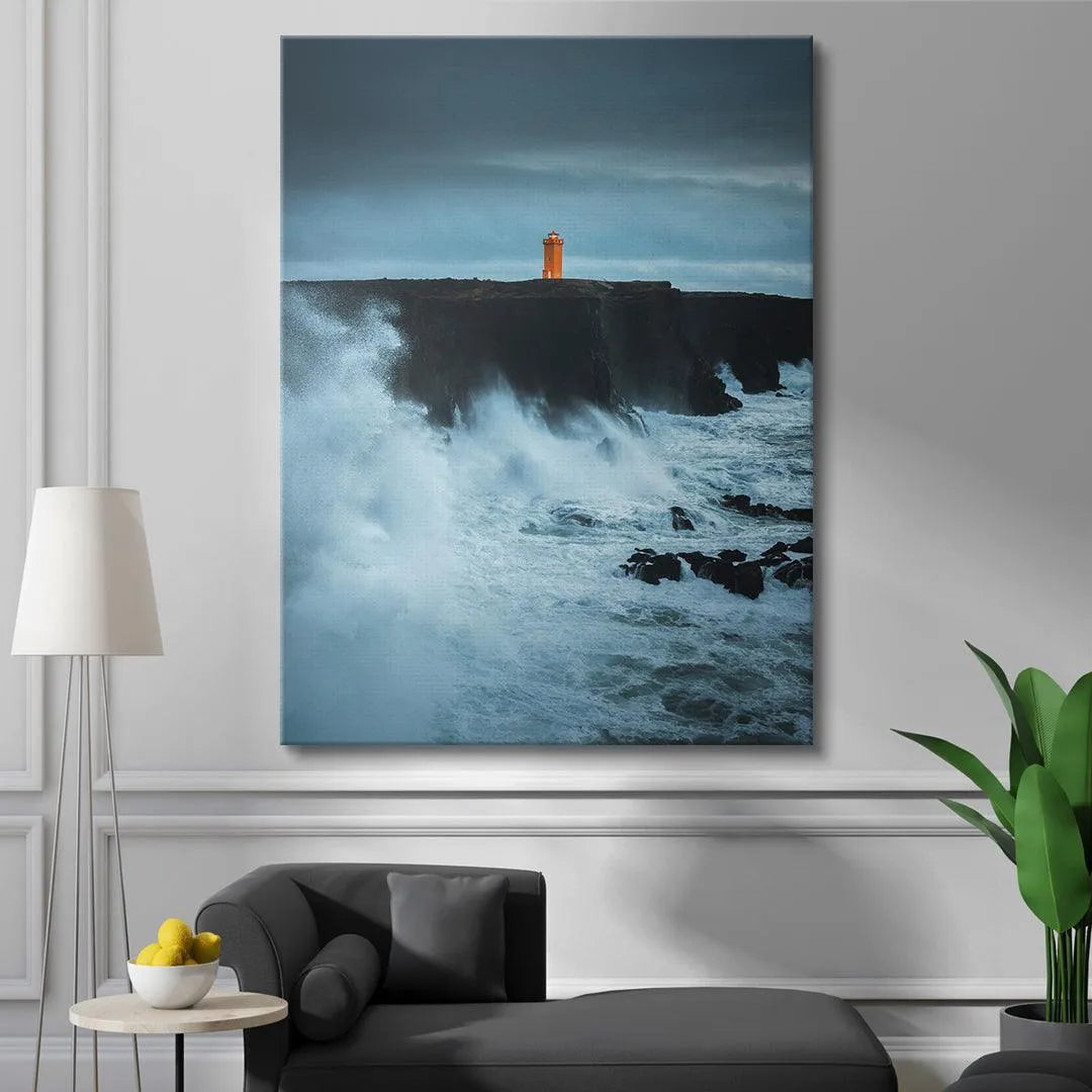 Wide shot perspective of the orange Lighthouse under a deep blue, brooding storm cloud sky.