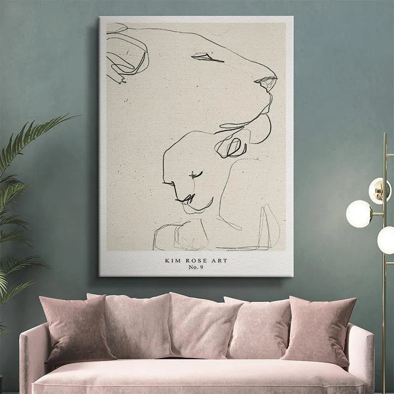 Angled shot of the framed 'Lioness - White' poster hanging in a clean, modern living room setting.