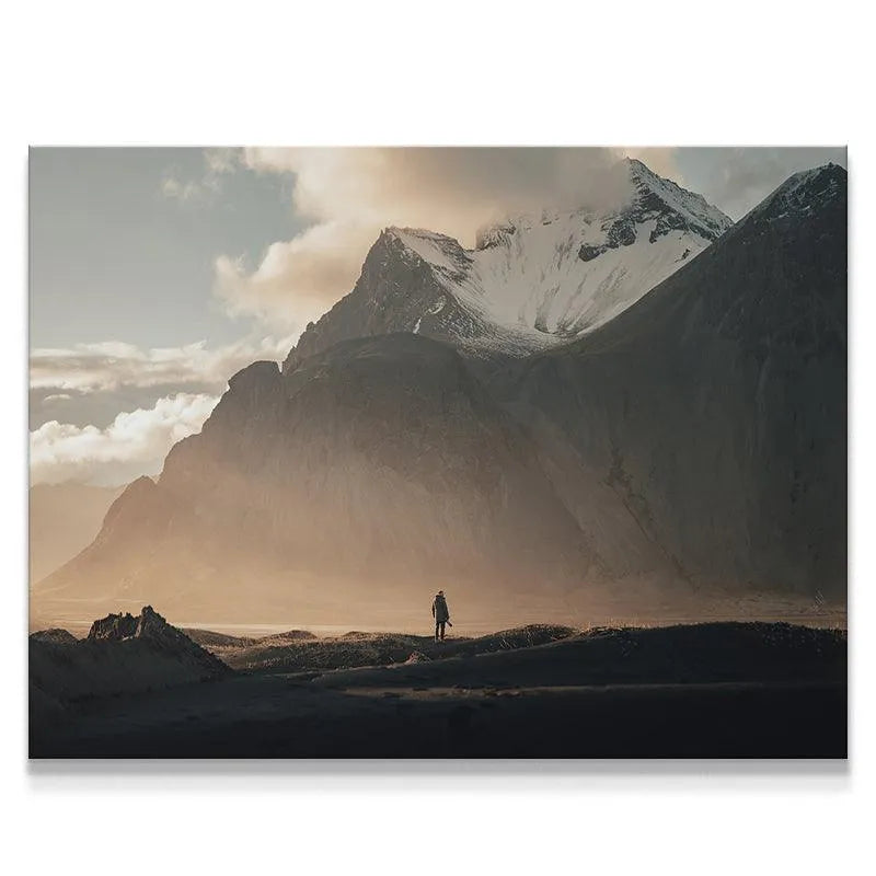 Wide shot of the vast snow-capped Icelandic mountain range featuring the tiny traveler in the 'Lonely Stokk' print.