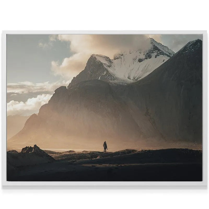 Dramatic golden hour lighting bathing the large central snow-covered peak featured prominently in 'Lonely Stokk' landscape art.