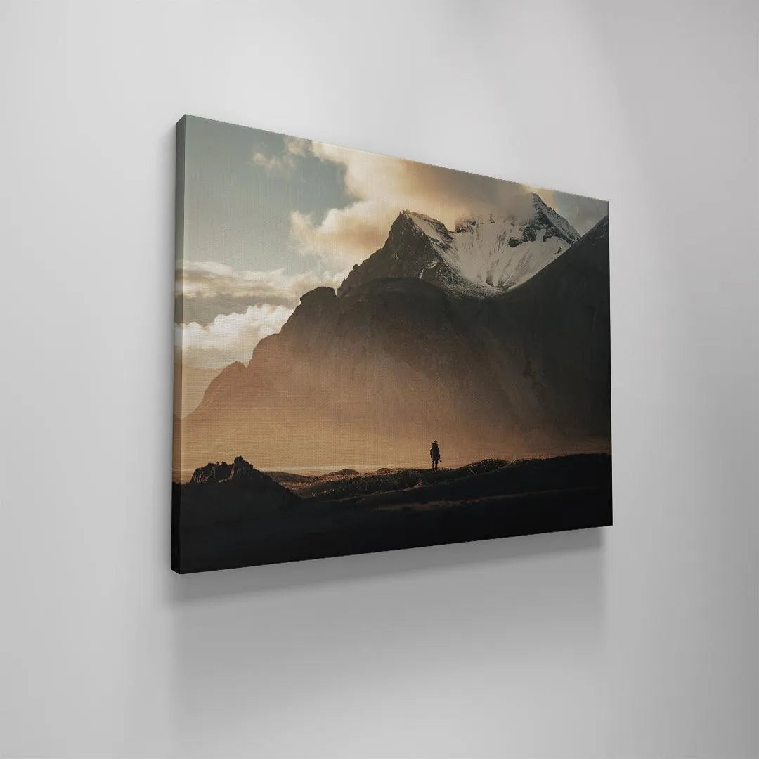 Soft, hazy atmospheric conditions and diffused clouds surrounding the jagged snowy summit visible in the 'Lonely Stokk' artwork.