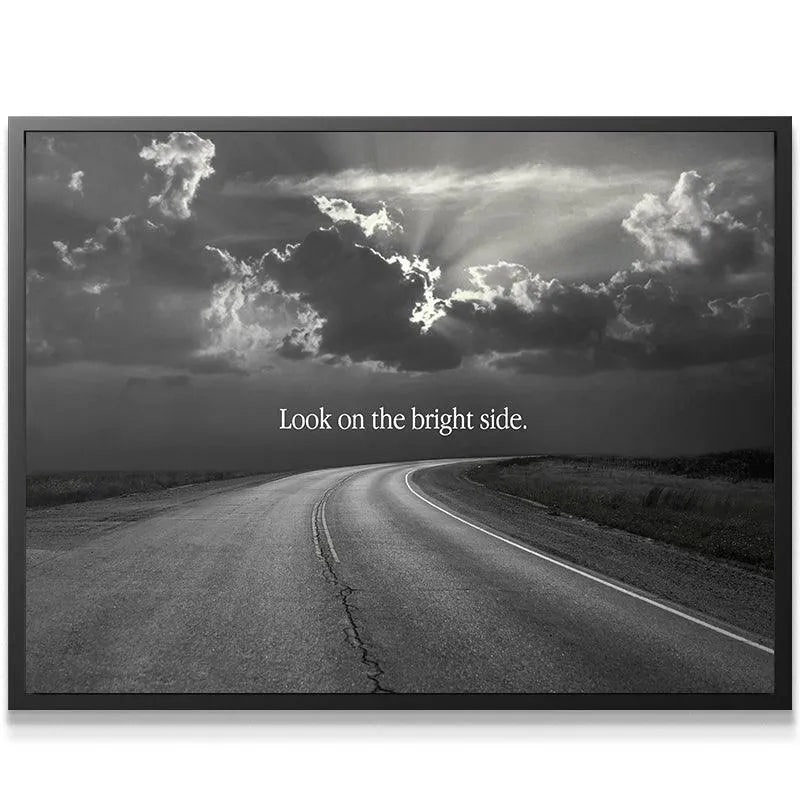 Close-up view of the curving asphalt road texture with the motivational quote Look On The Bright Side.