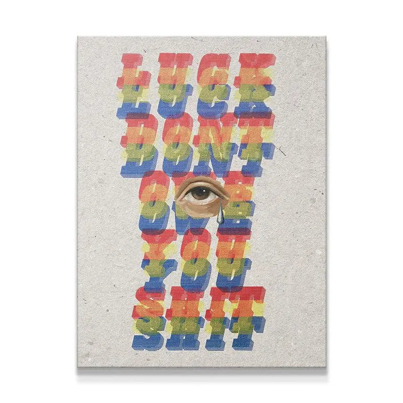 Full frontal view of the 'Luck Don't Owe You Shit' print on textured, gray paper stock with rainbow typography.