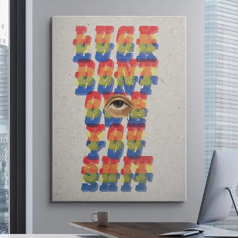 Corner view highlighting the raw paper edge texture of the inspirational 'Luck Don't Owe You Shit' poster.