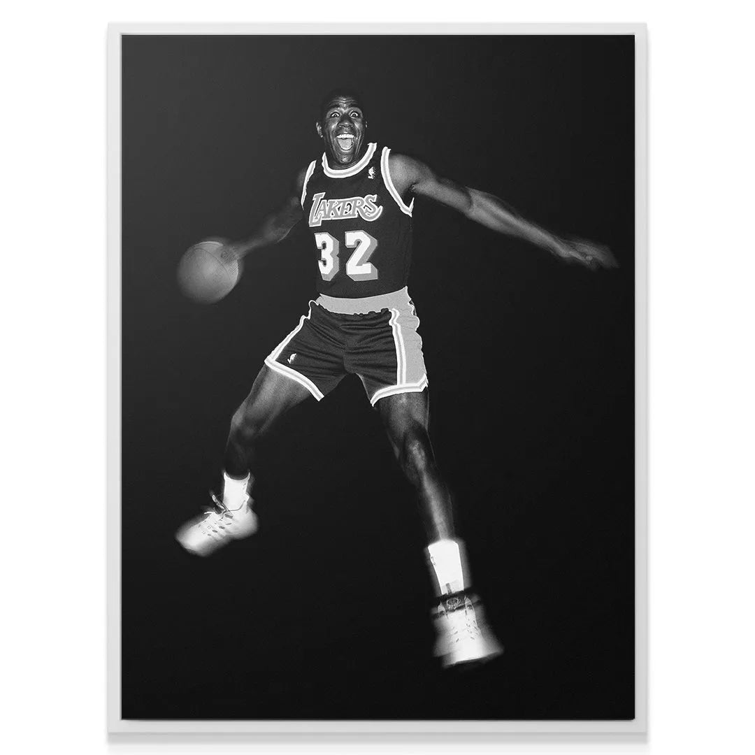 Dynamic black and white photograph capturing the motion blur of Magic Johnson - It's Magic mid-dribble.