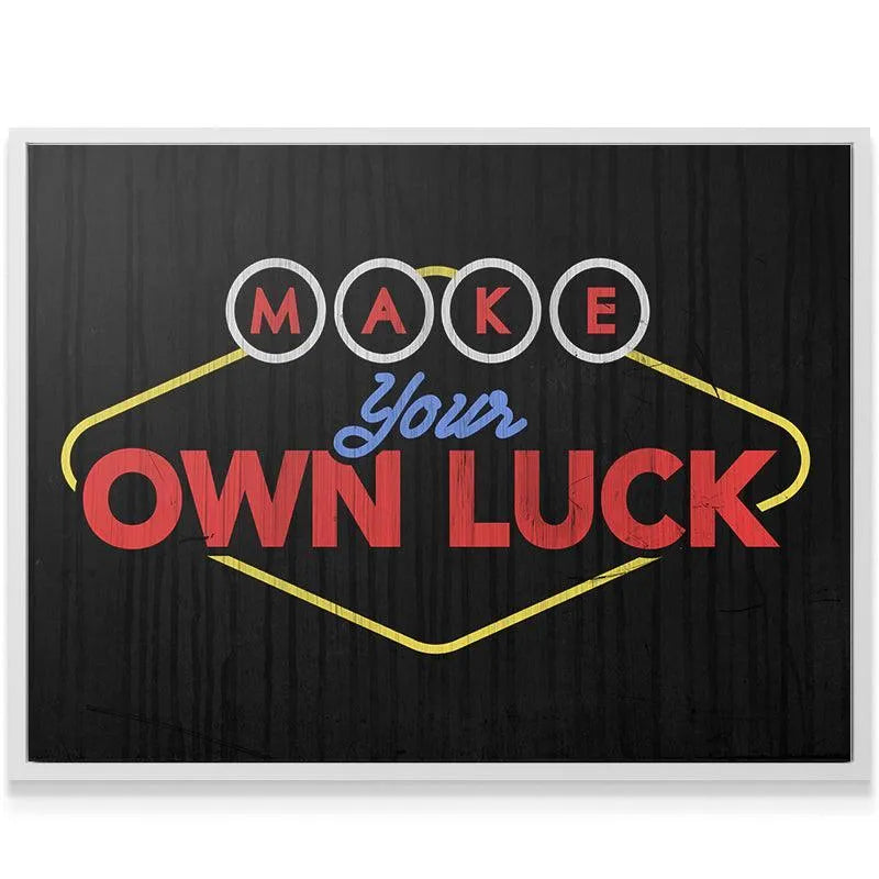 Lifestyle mockup showing the 'Make Your Own Luck' canvas hanging above a modern desk in a home office setting.