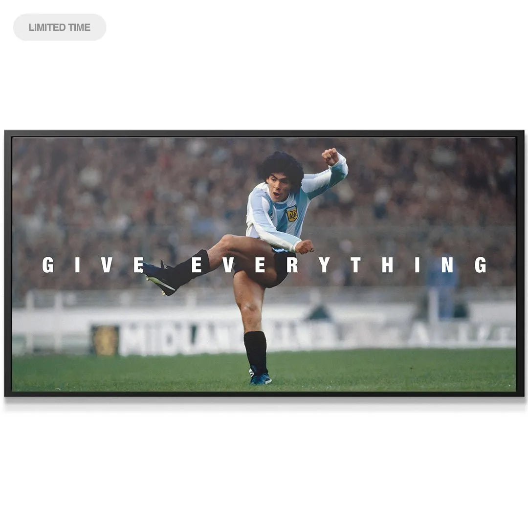 Lifestyle view of the 'Maradona - Give Everything' wall art displayed prominently above a modern sofa.