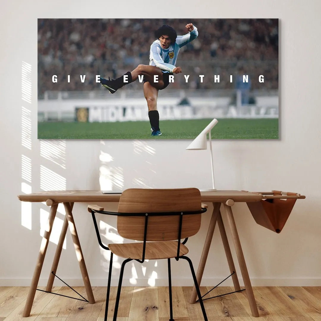Dynamic action angle of Diego Maradona mid-play, titled 'Maradona - Give Everything', showing intense focus.