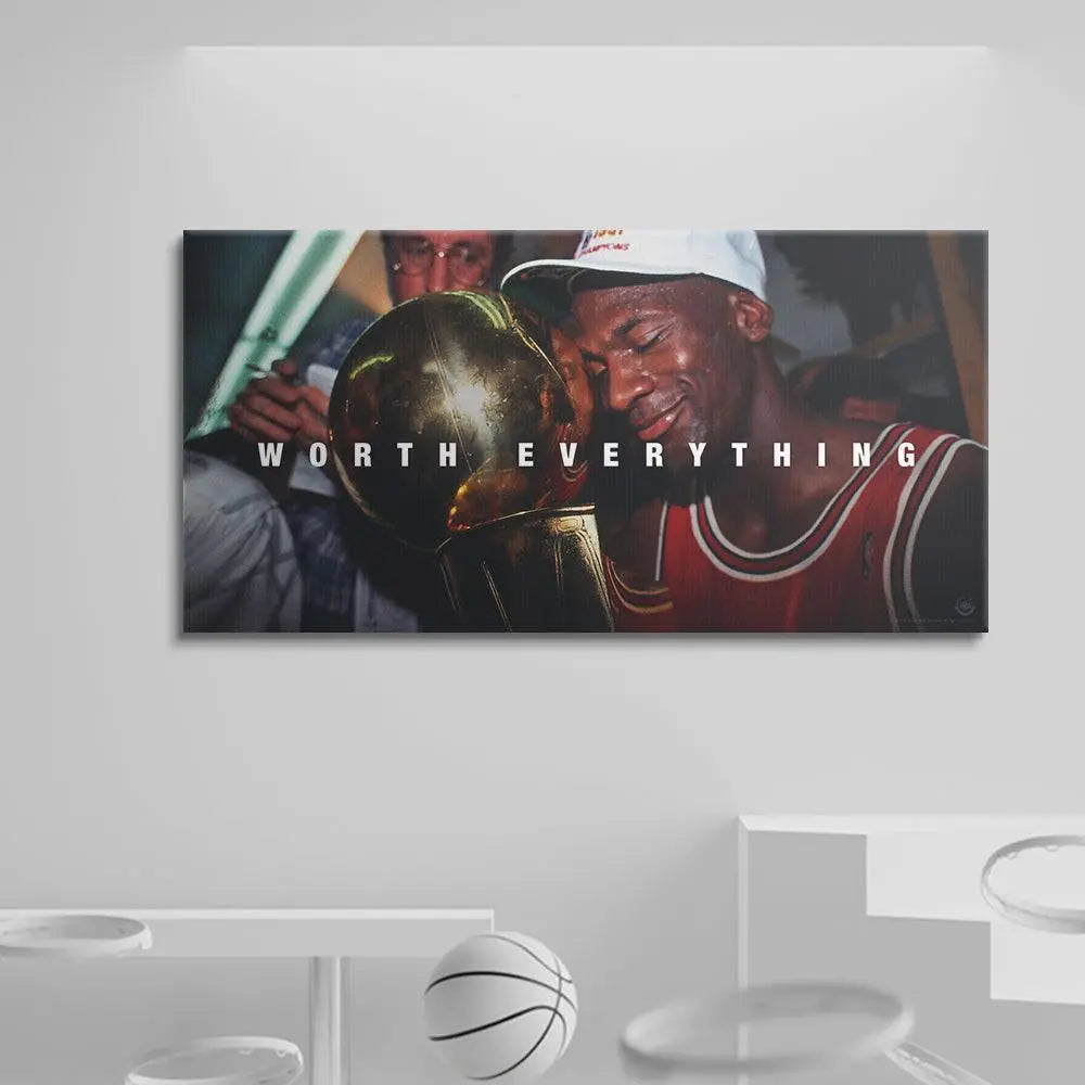 Framed picture of a basketball player holding a trophy with 'Worth Everything' text, displayed on a white wall.
