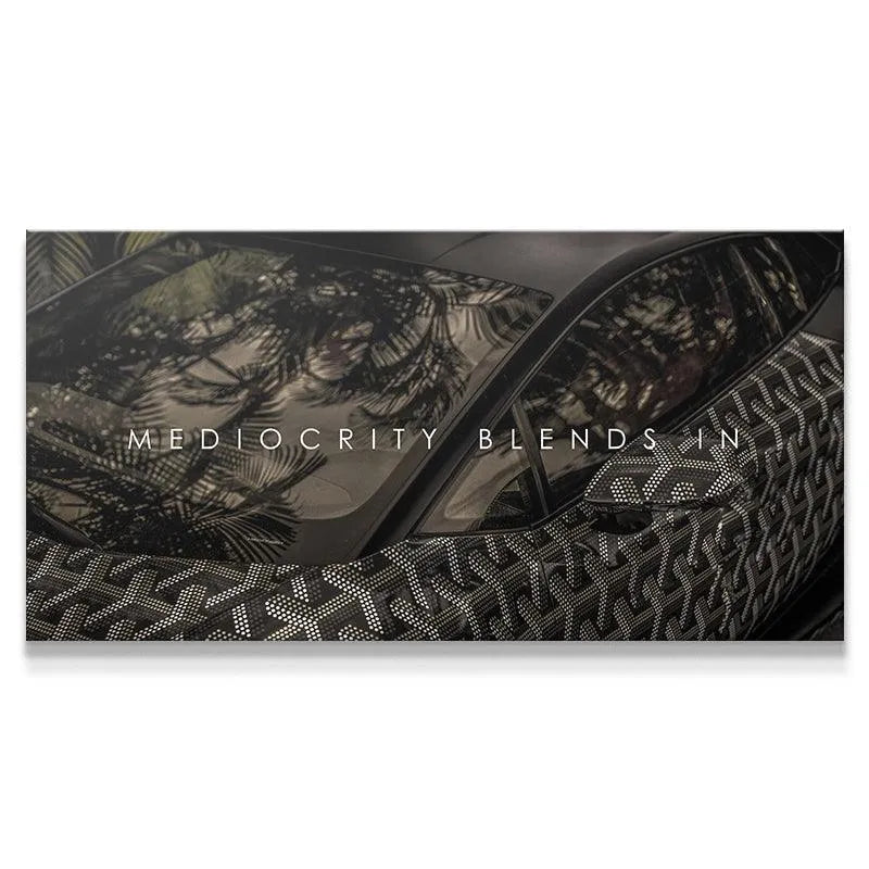 Close-up of patterned vinyl wrap on luxury sports car featuring 'Mediocracy Blends In'.