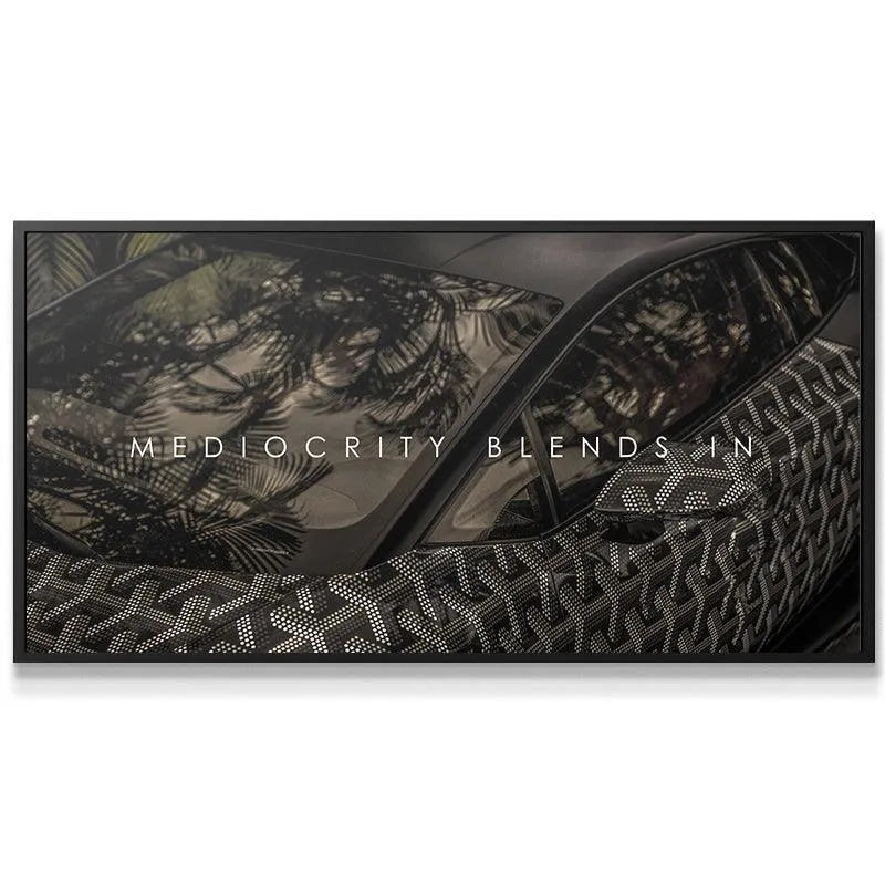 Side profile view of matte black supercar windshield reflecting palm trees with 'Mediocracy Blends In' overlaid.