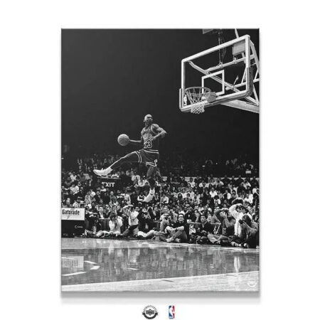 Black and white action shot of Michael Jordan - Frozen In Time mid-dunk, showing the reflective court texture.