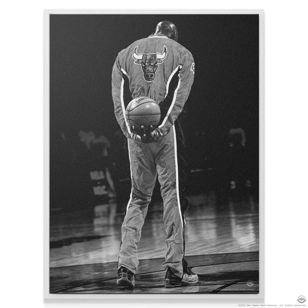 Wide view of Michael Jordan - National Anthem standing alone on the polished hardwood court.